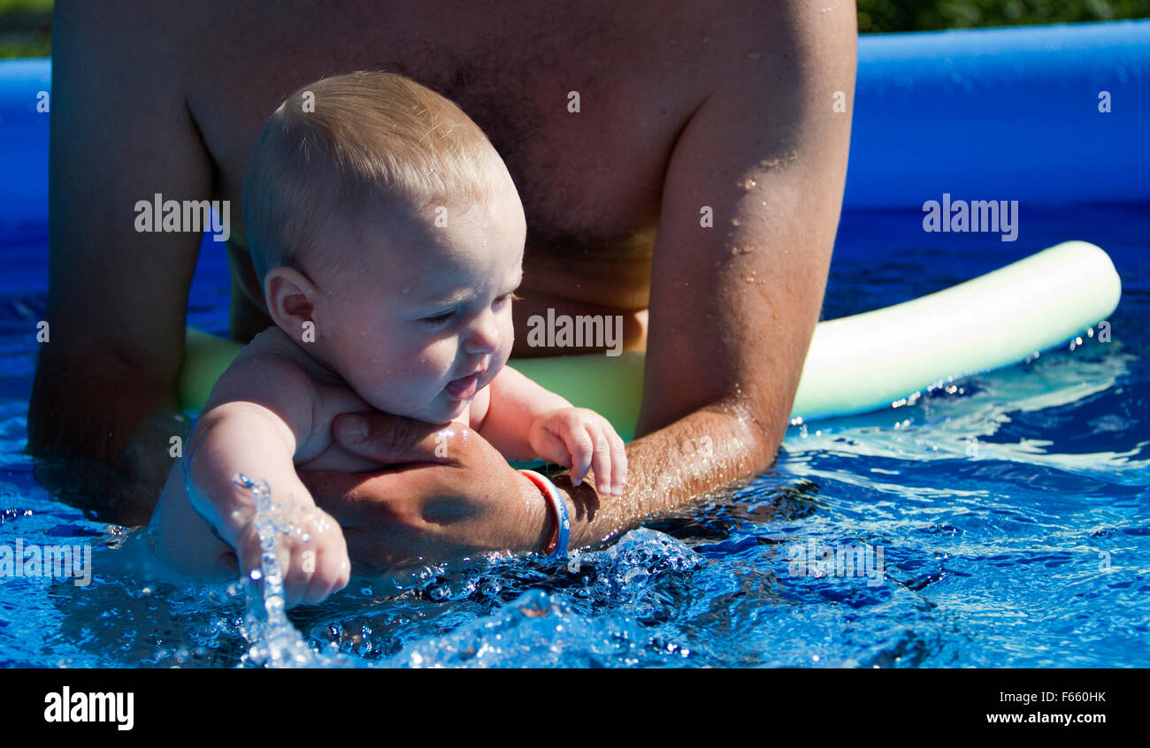 Little baby in the pool with her dad Stock Photo Alamy
