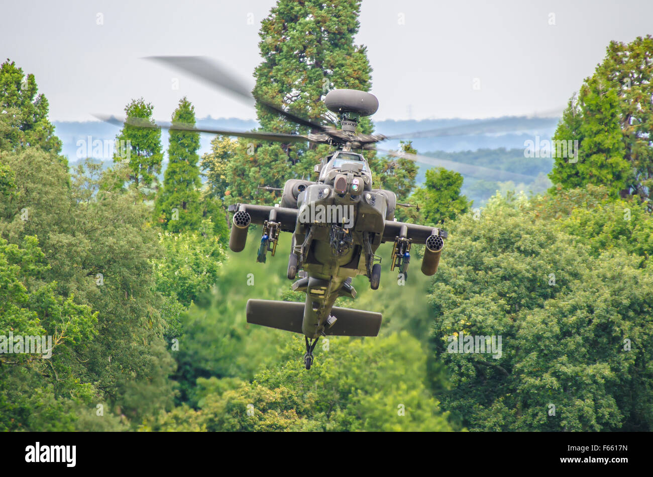 AgustaWestland Apache is a licence-built version of the AH-64D Apache Longbow attack helicopter for the British Army. In trees. Tank killer Stock Photo