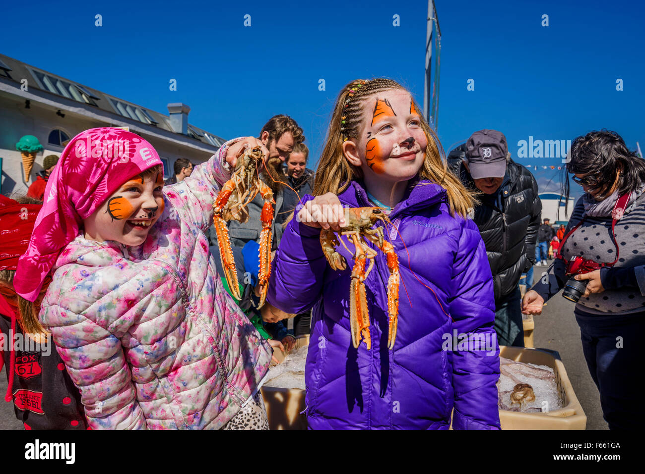 Girls holding lobsters at the annual Seaman's day festival, Reykjavik, Iceland Stock Photo