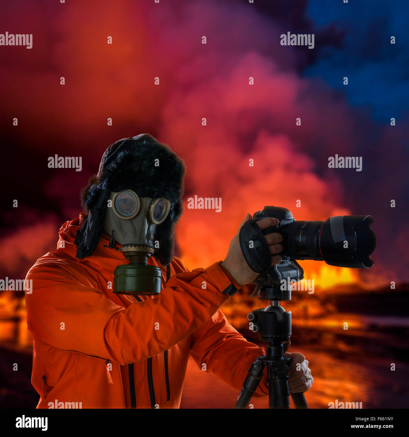 Photographer wearing a gas mask in front of glowing lava. Holuhraun, Bardarbunga Volcano eruption, Iceland Stock Photo