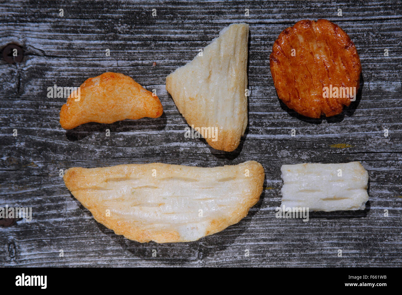 Crackers in geometric design on raw, aged wood. Stock Photo