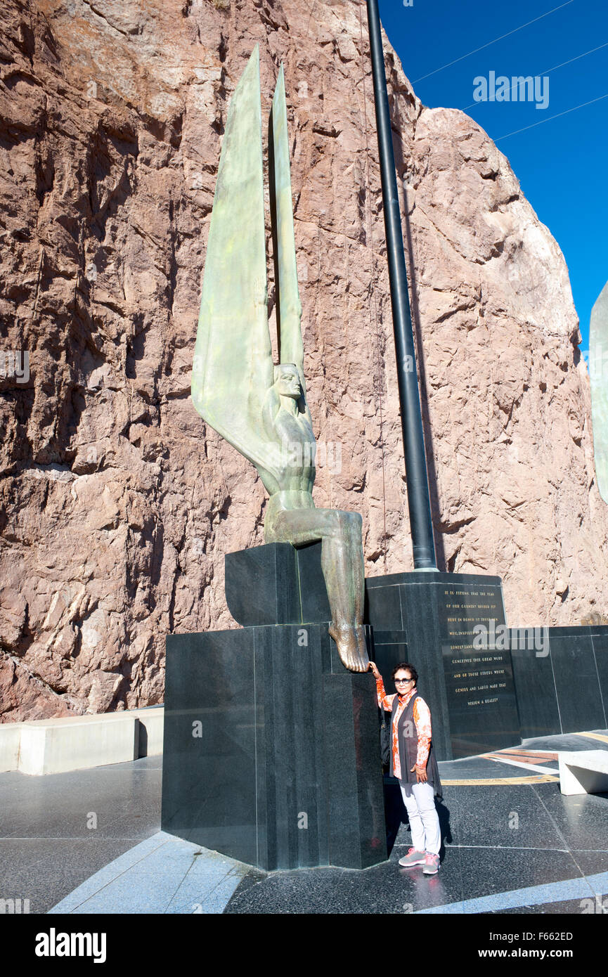 People rubbing toes of one of the Winged figures of the Republic at Hoover dam for good luck at gambling. Stock Photo