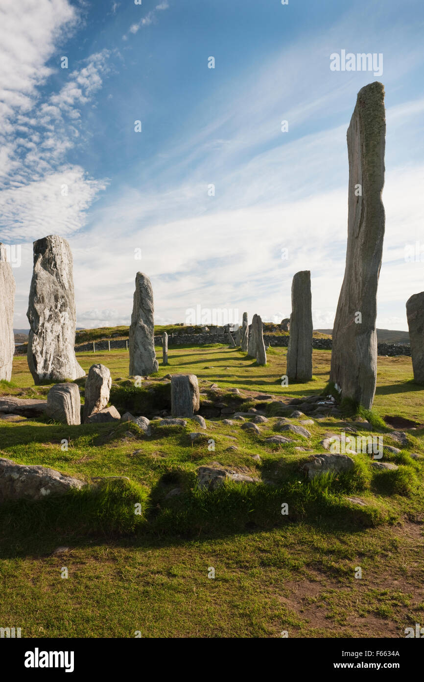 Looking S at Callanish (Calanais) Standing Stones, Isle of Lewis: part of central ring with chambered cairn & tall monolith, plus S row & knoll. Stock Photo