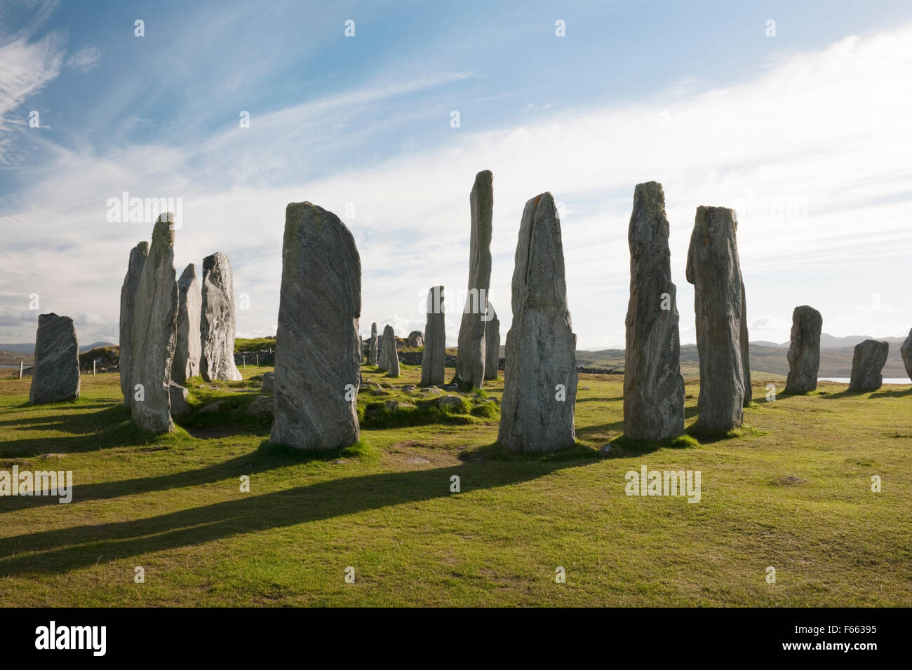 Looking SSW at Callanish (Calanais) Standing Stones, Isle of Lewis: central ring, chambered cairn & tall monolith, plus stones of S, W & E rows Stock Photo