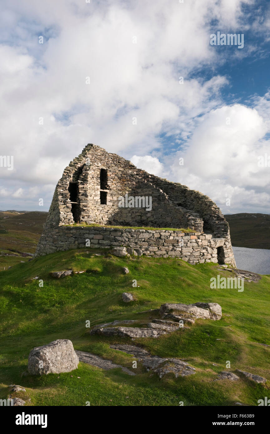 Looking SSE at Dun Carloway broch tower, Isle of Lewis, showing entrance on R (N) and the inner and outer drystone walls containing a staircase. Stock Photo