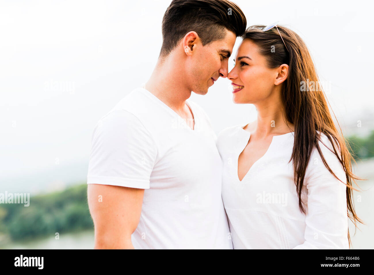 Young beautiful couple rubbing noses as a sign of love and about to kiss each other Stock Photo