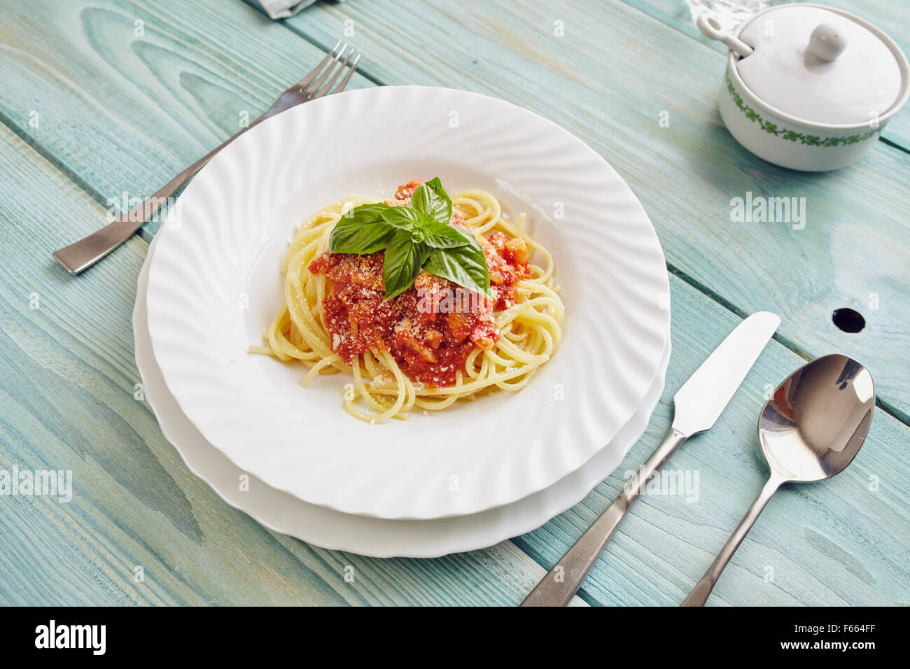 spaghetti amatriciana on a blue wooden table (Italian dish) Stock Photo