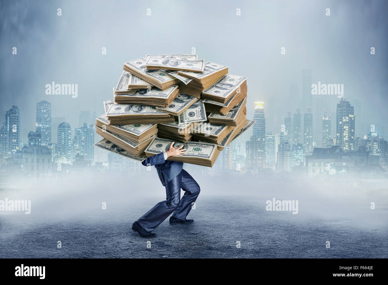 Businessman carrying huge heap of money Stock Photo - Alamy