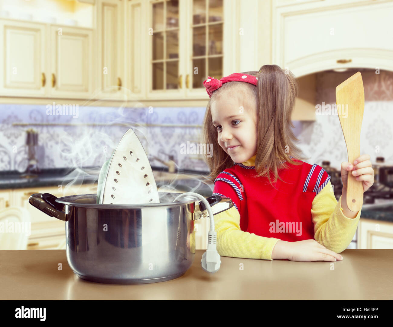 Cute little girl cooking iron in the pot Stock Photo