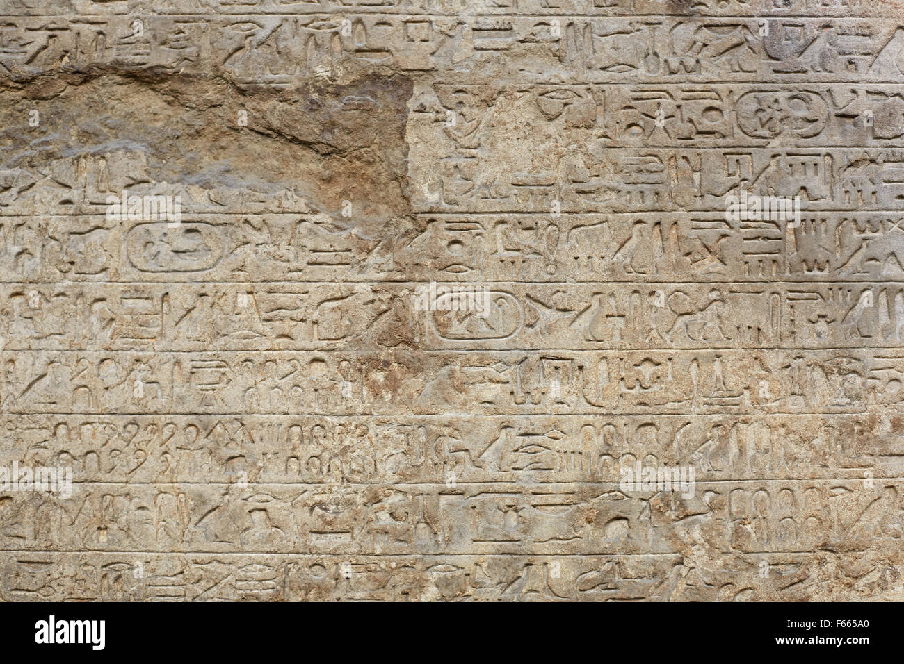 Egyptian hieroglyphs writing on old broken stone background Stock Photo