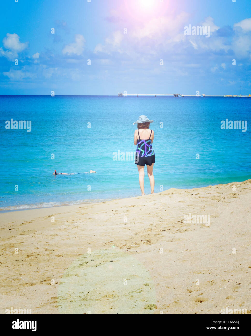 Man watching woman on beach hi-res stock photography and images - Alamy