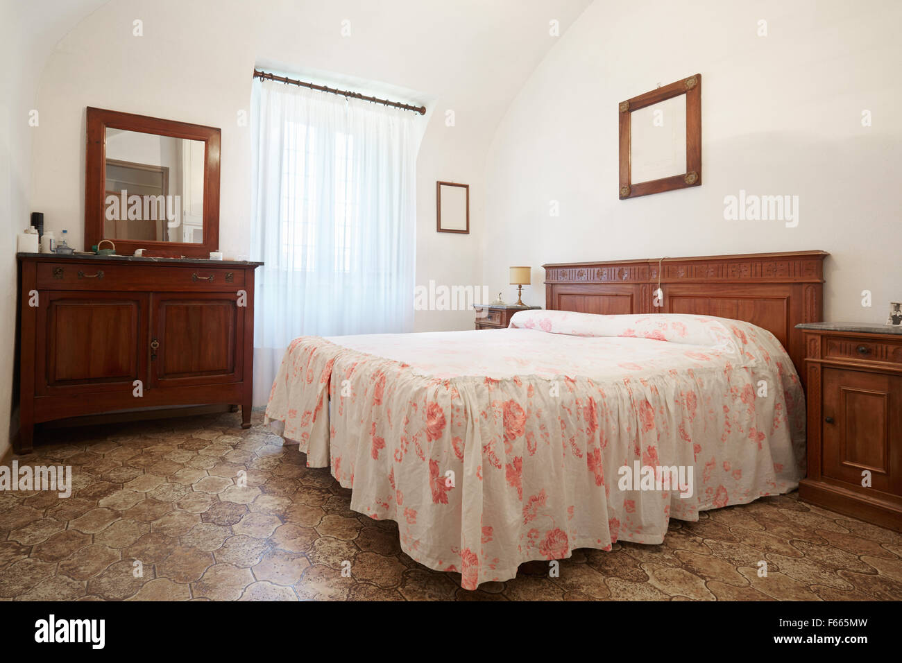 Old bedroom with queen size bed in ancient house Stock Photo