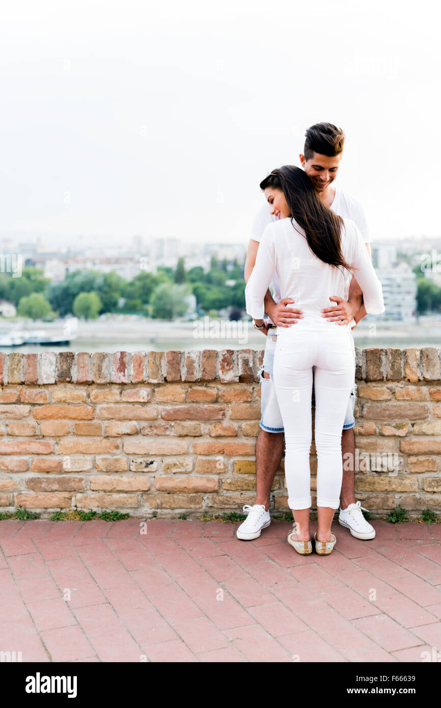 Young couple holding each other around waist and being close to each other Stock Photo