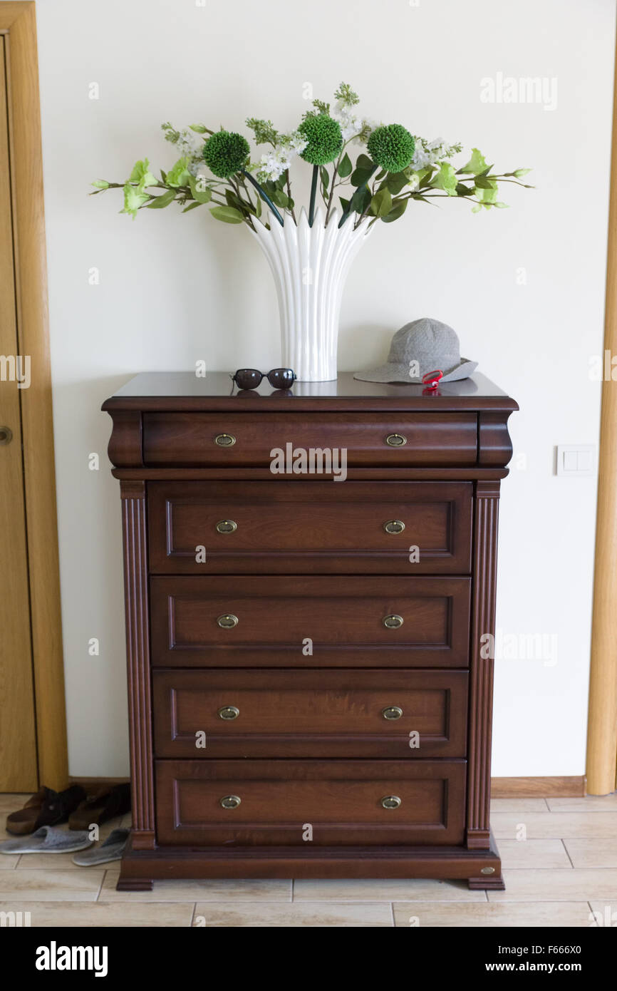 the dresser from a brown tree on which is cost by flowers Stock Photo