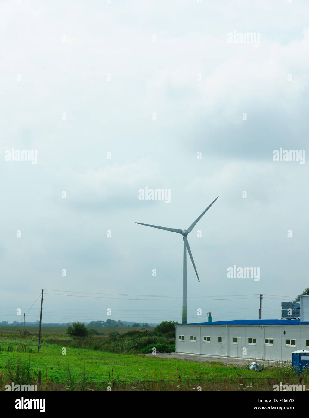 the wind-driven generator in the middle of a field serves for development of the cheap and ecology electric power Stock Photo