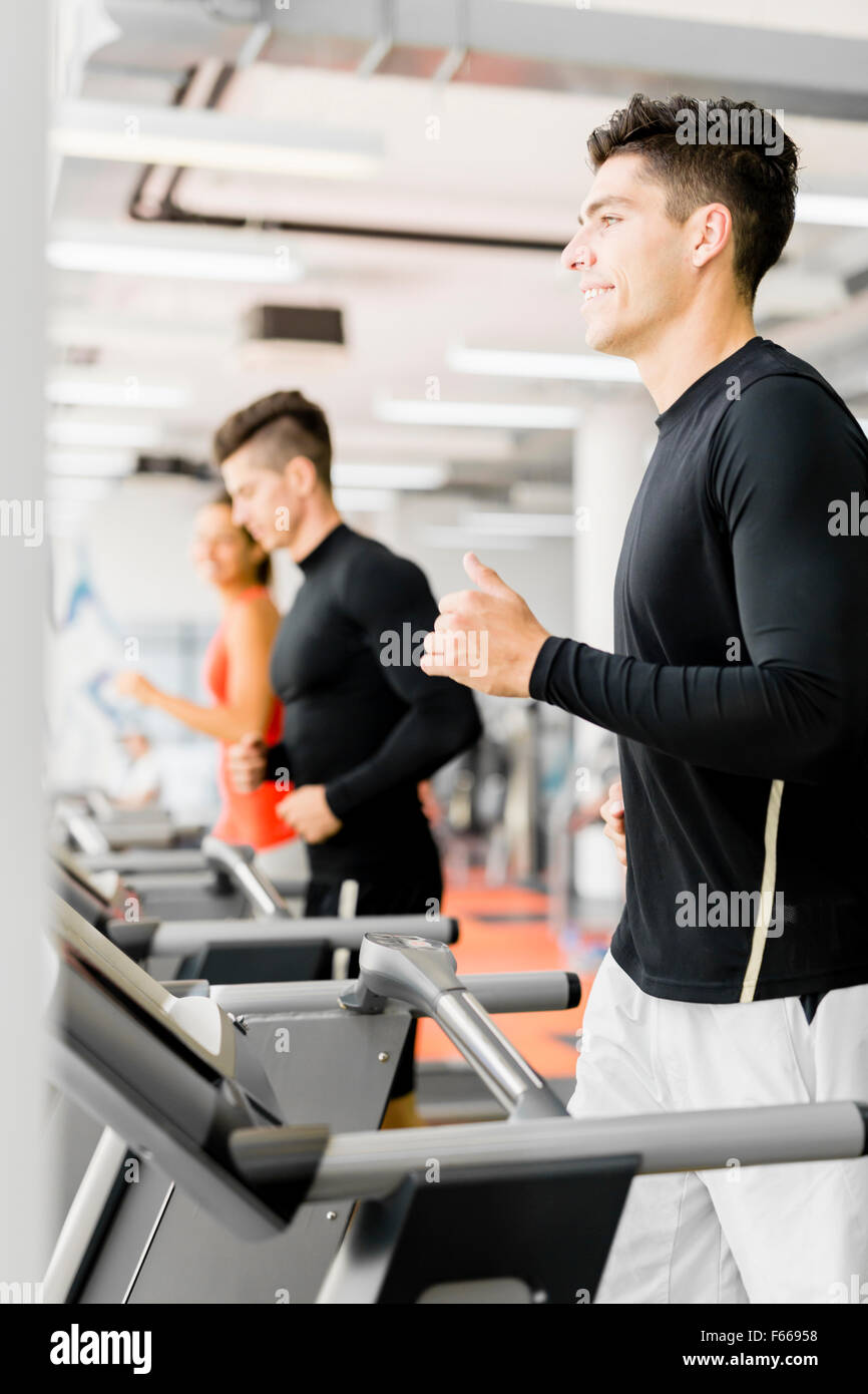Group of young people running on treadmills in a fitness center Stock Photo