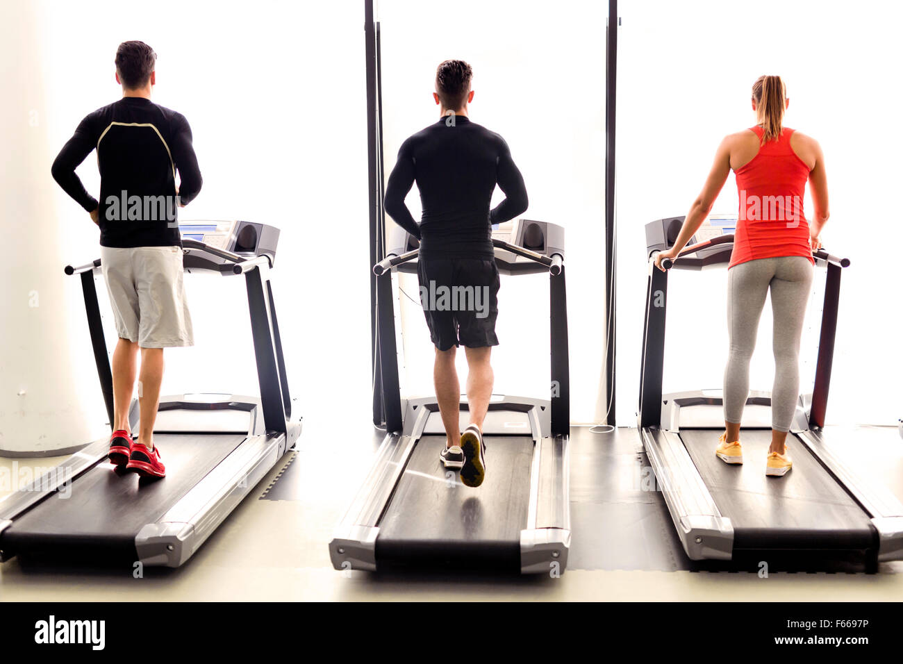Group of young people using treadmills in a fitness center Stock Photo