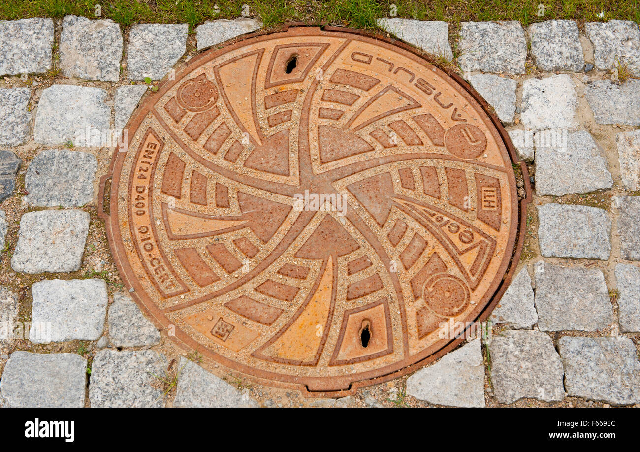 Cast iron manhole cover of sewage well by Fansuld in park Lazienki Krolewskie w Warszawie, Royal Baths Park, Warsaw, Poland, Eur Stock Photo