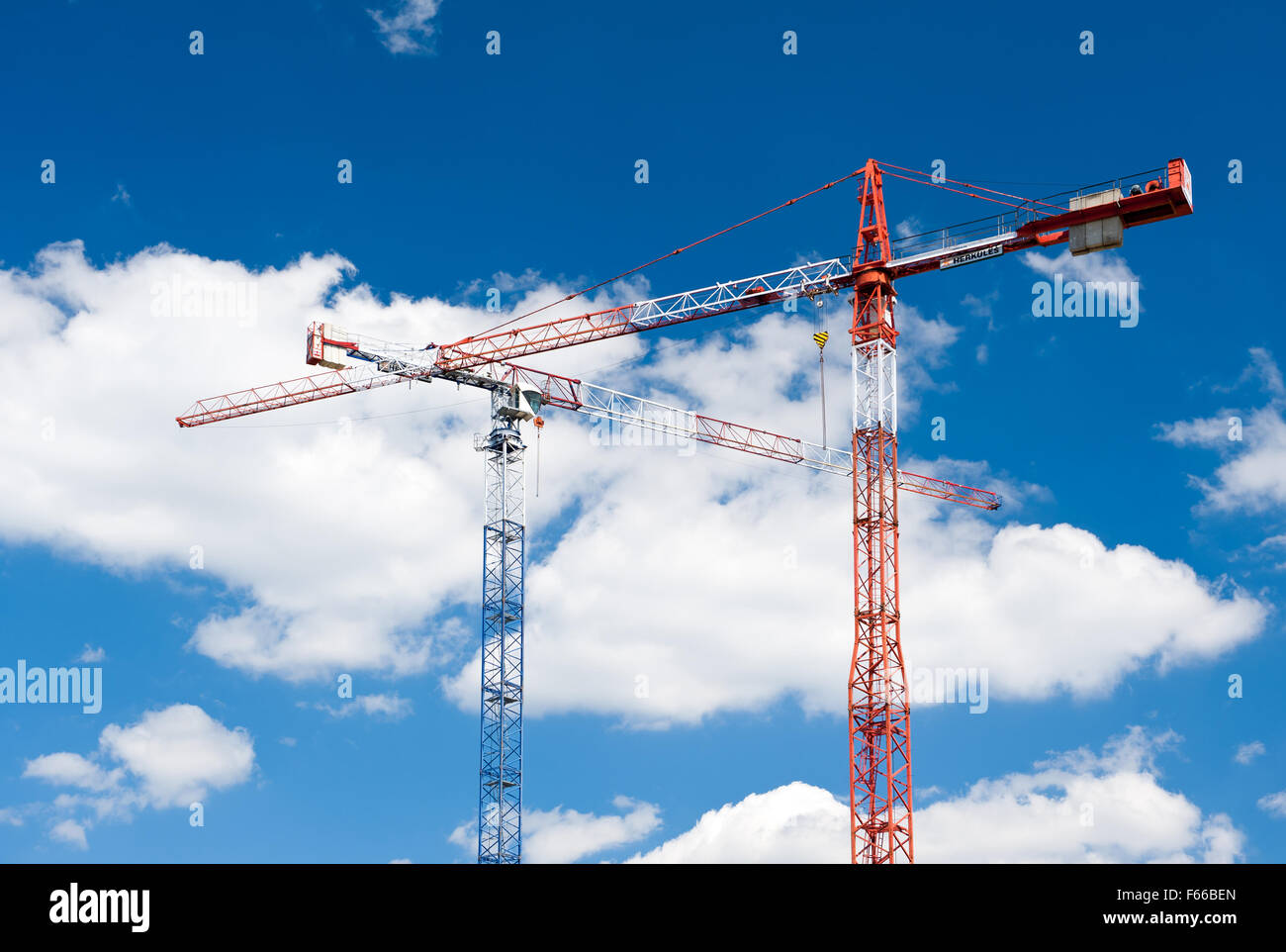 Two cranes build equipment, heavy industry Herkules high construction machines on the blue sky in sunny day in Poland, Europe... Stock Photo