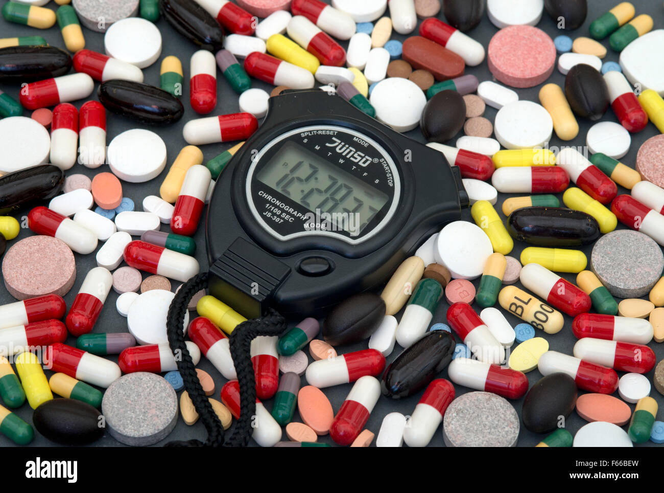 Concept picture of selection of drugs with a sports stopwatch,re Russian athlete doping scandal involving WADA IAAF.a UK Russia Stock Photo
