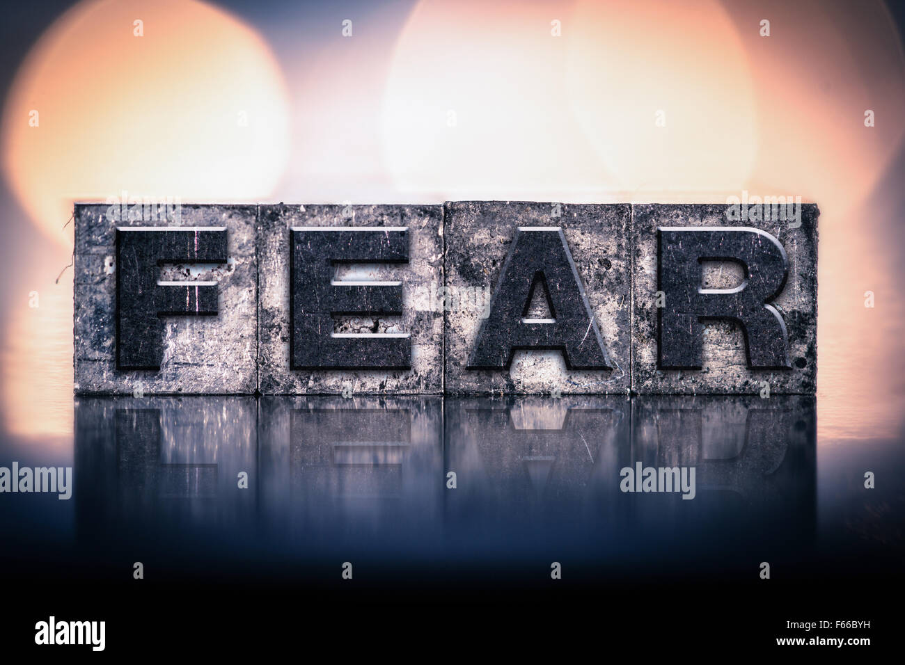 The word 'FEAR' written in vintage ink stained letterpress type. Stock Photo