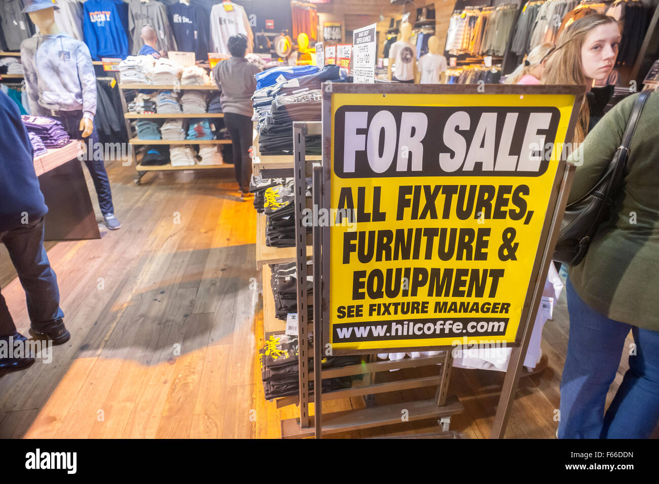 Big discounts on merchandise and fixtures are advertised in the Quicksilver store in Times Square in New York on Sunday, November 8, 2015. Quicksilver after filing for Chapter 11 bankruptcy protection will be closing 27 out of 122 stores in the U.S. This includes their Roxy and DC brands. The company is affected by the mass exodus of teens, their core customers, who are spending their money on electronics rather than clothing. The same problem effects other teen retailers such as Abercrombie & Fitch and Aeropostale.  (© Richard B. Levine) Stock Photo