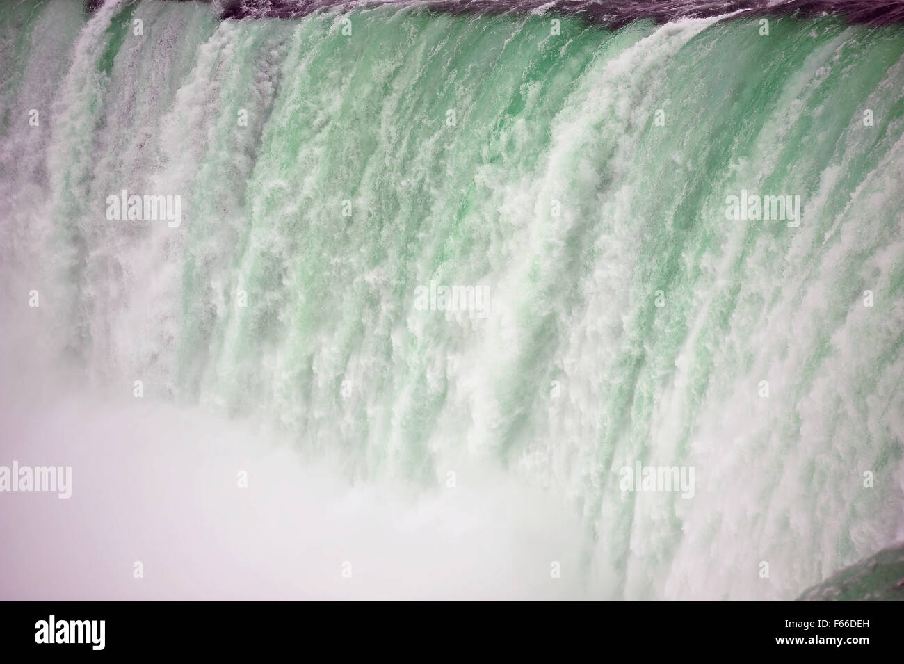 Water rushes over the top of the Horseshoe falls on the Canadian side of the Niagara Falls in Ontario. Stock Photo