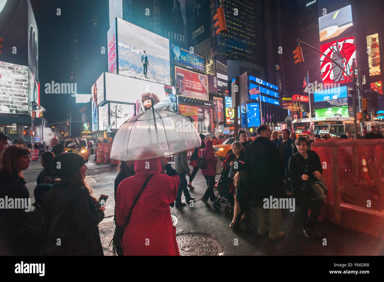 Pedestrians cross a busy Times Square intersection in New York on ...