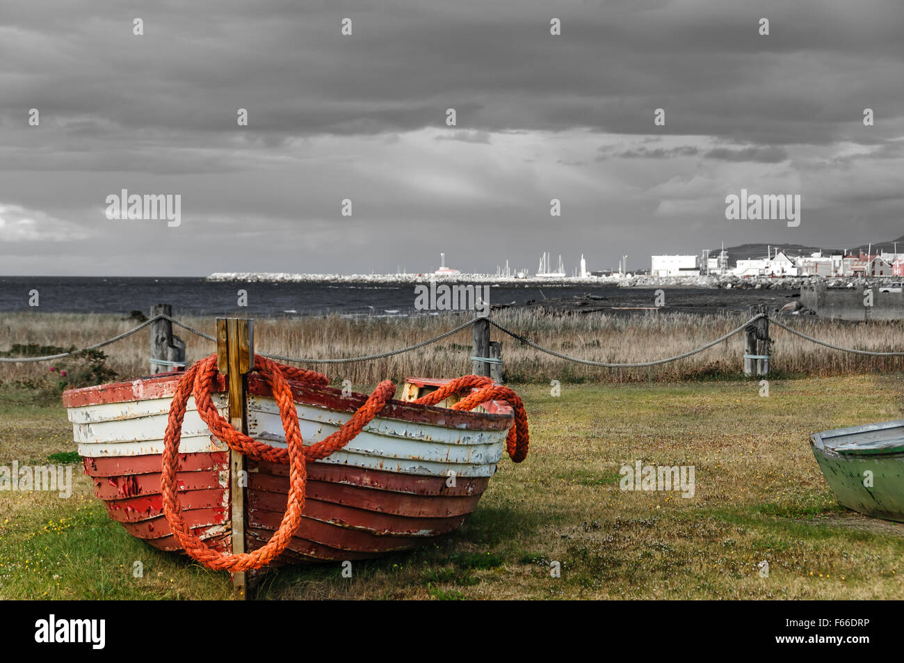 abandoned fishing boat with rope and scenic view of village of Mont SteAnne, Quebec, Canada