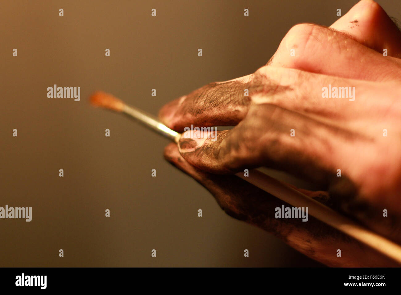 An artist holds a paint brush Stock Photo Alamy