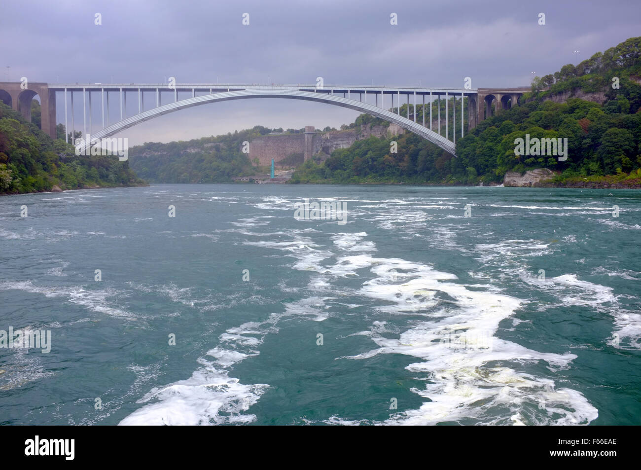 The Rainbow Bridge seen from onboard the Canadian Hornblower boat at the Niagara Falls in Ontario. Stock Photo
