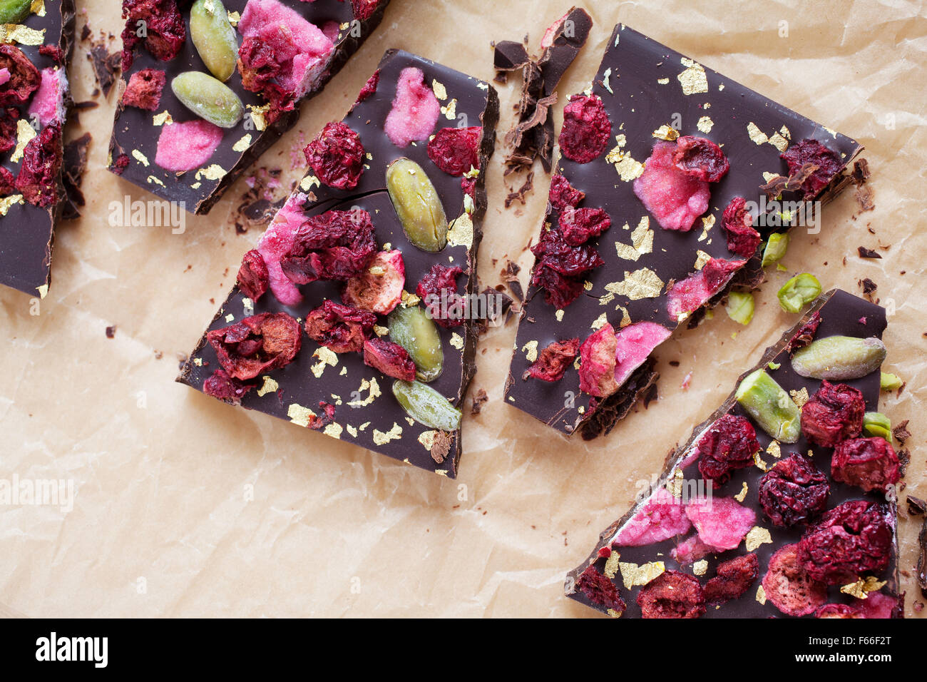 Handmade chocolate with berries, jpistachios and edible gold Stock Photo