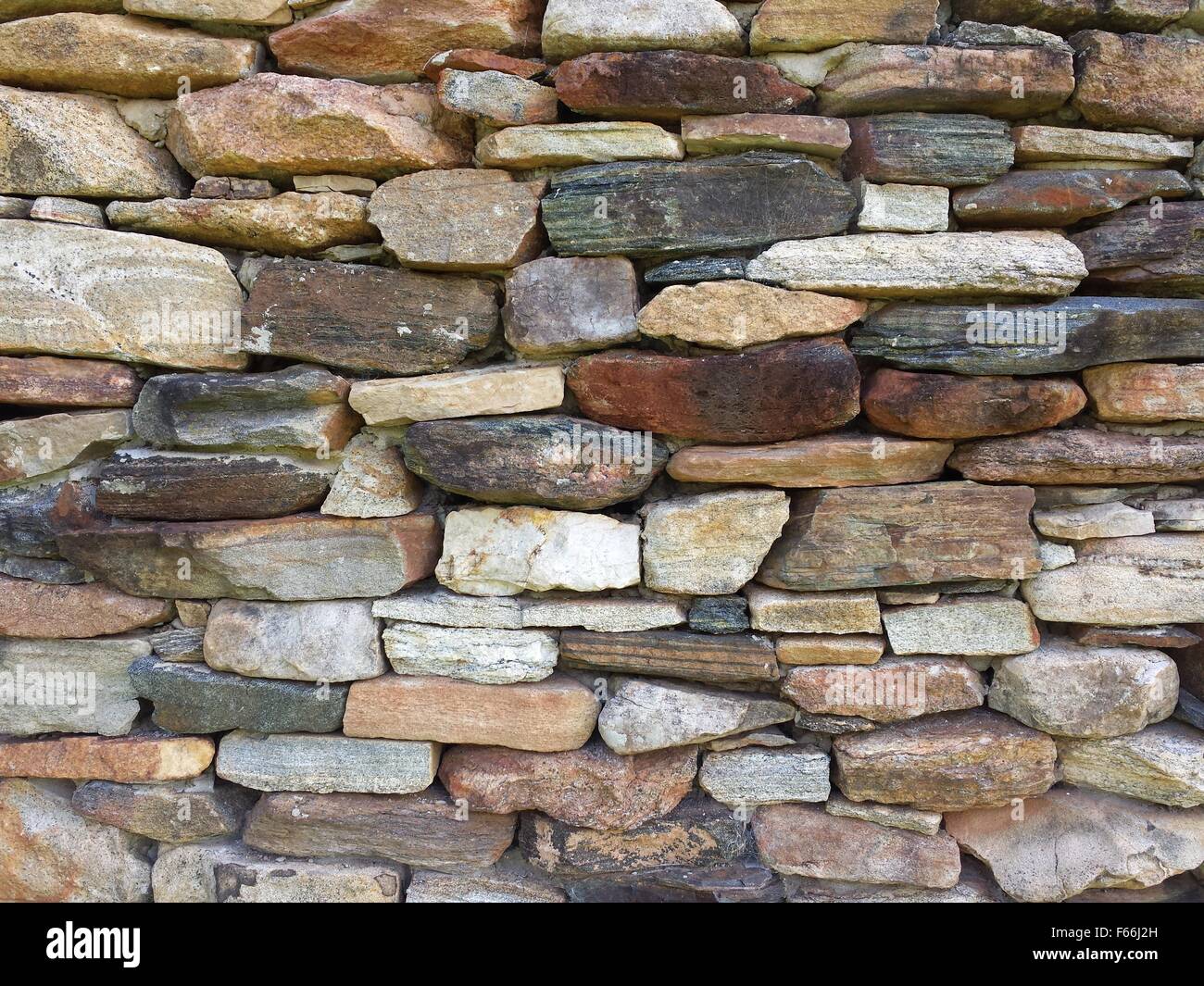 Stone wall pattern from old log cabin chimney Stock Photo