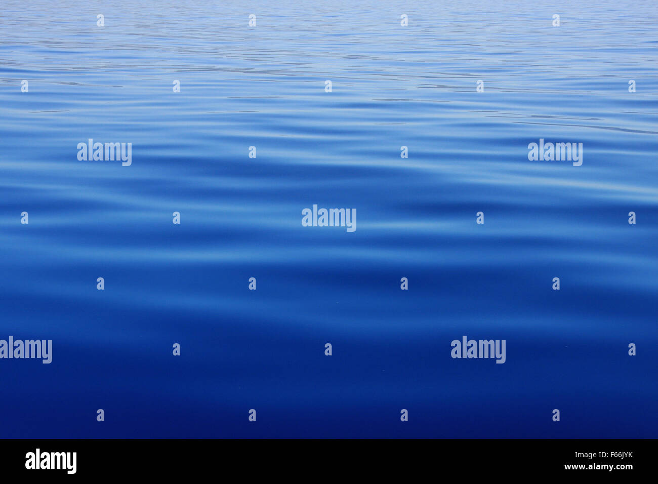 Ripples on a blue water background Stock Photo - Alamy