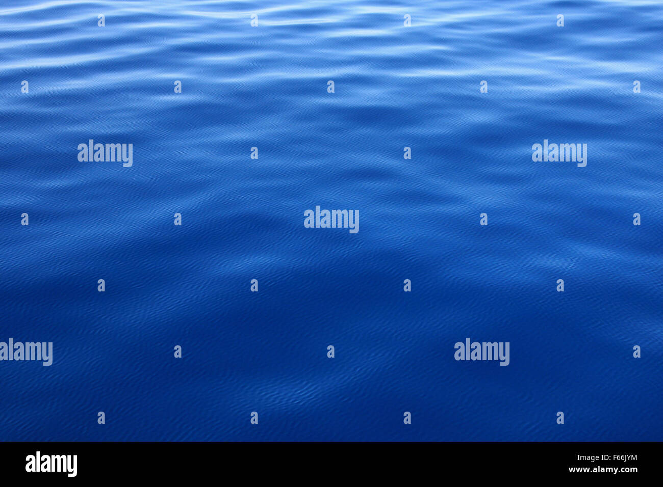 Ripples on a blue water background Stock Photo - Alamy