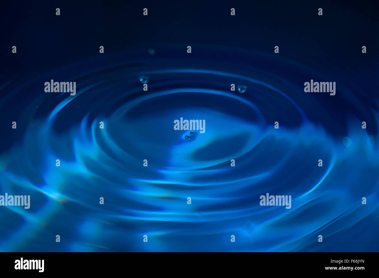 Ripples on a blue water background Stock Photo - Alamy