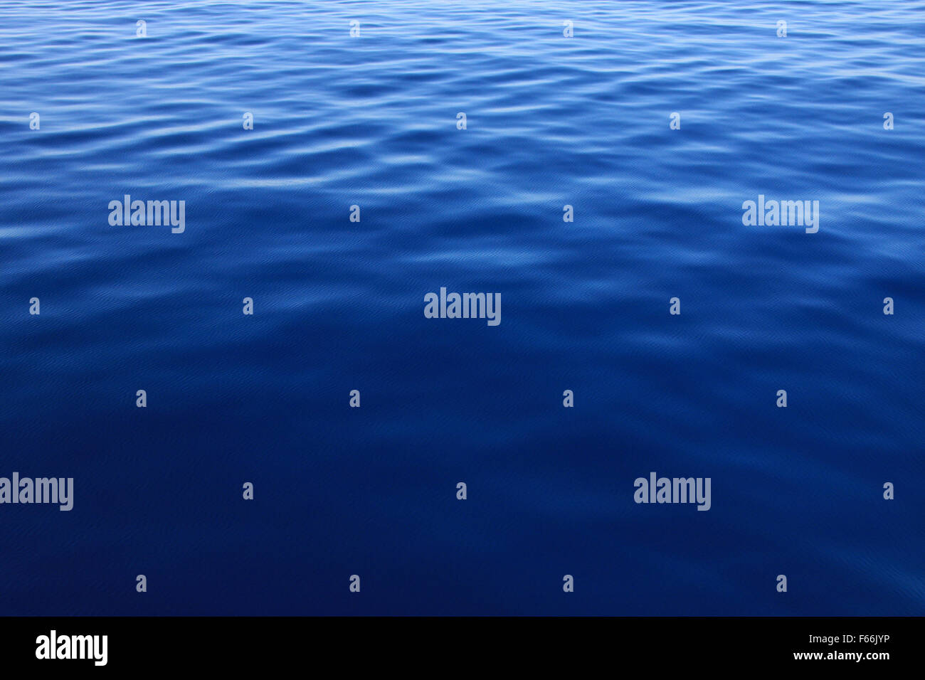 Ripples on a blue water background Stock Photo - Alamy