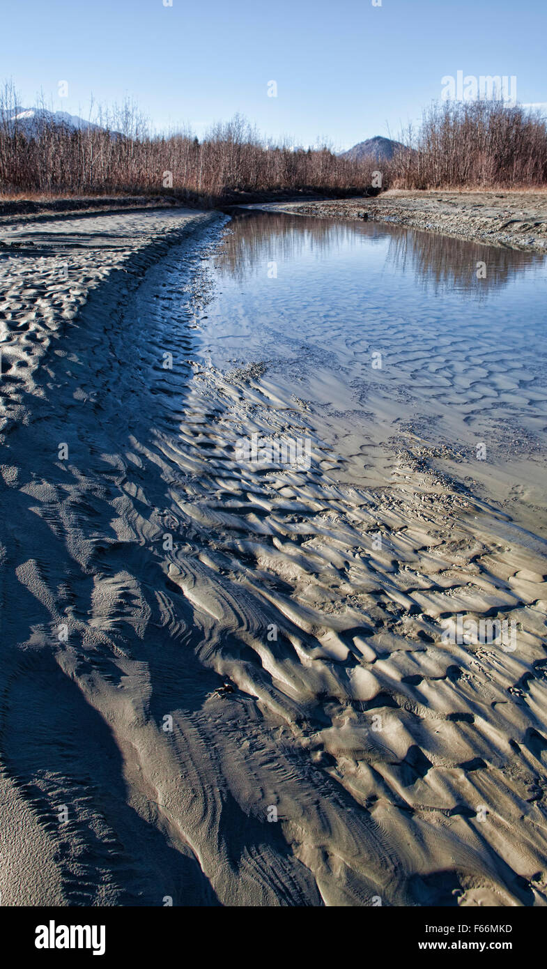 Drying river channel in Southeast Alaska with patterns in the silt. Stock Photo