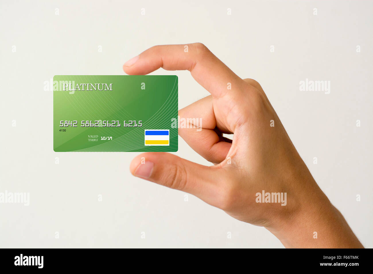 closeup of green credit card holded by hand. Stock Photo