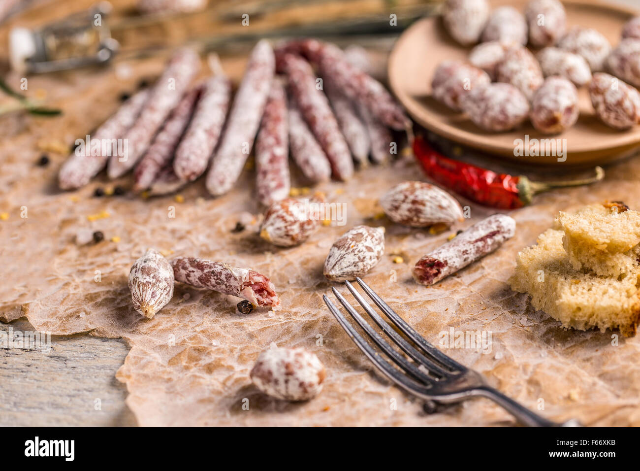 Different kinds of italian salami on rumpled paper Stock Photo Alamy