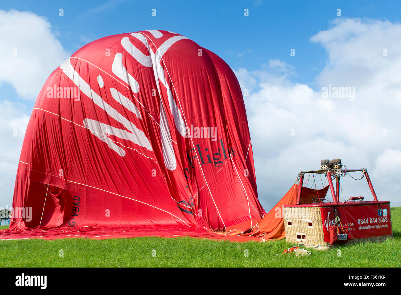 Virgin hot air balloon on ground slowly deflating, Cumbria, UK. Stock Photo
