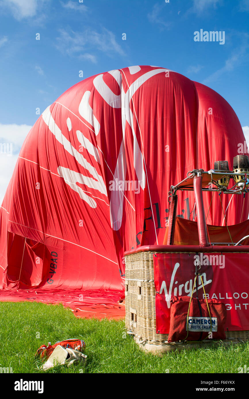 Virgin hot air balloon on ground slowly deflating, Cumbria, UK. Stock Photo