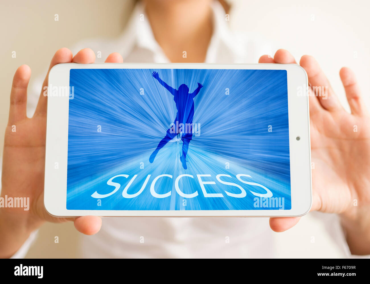 The Woman holds a tablet with success concept Stock Photo