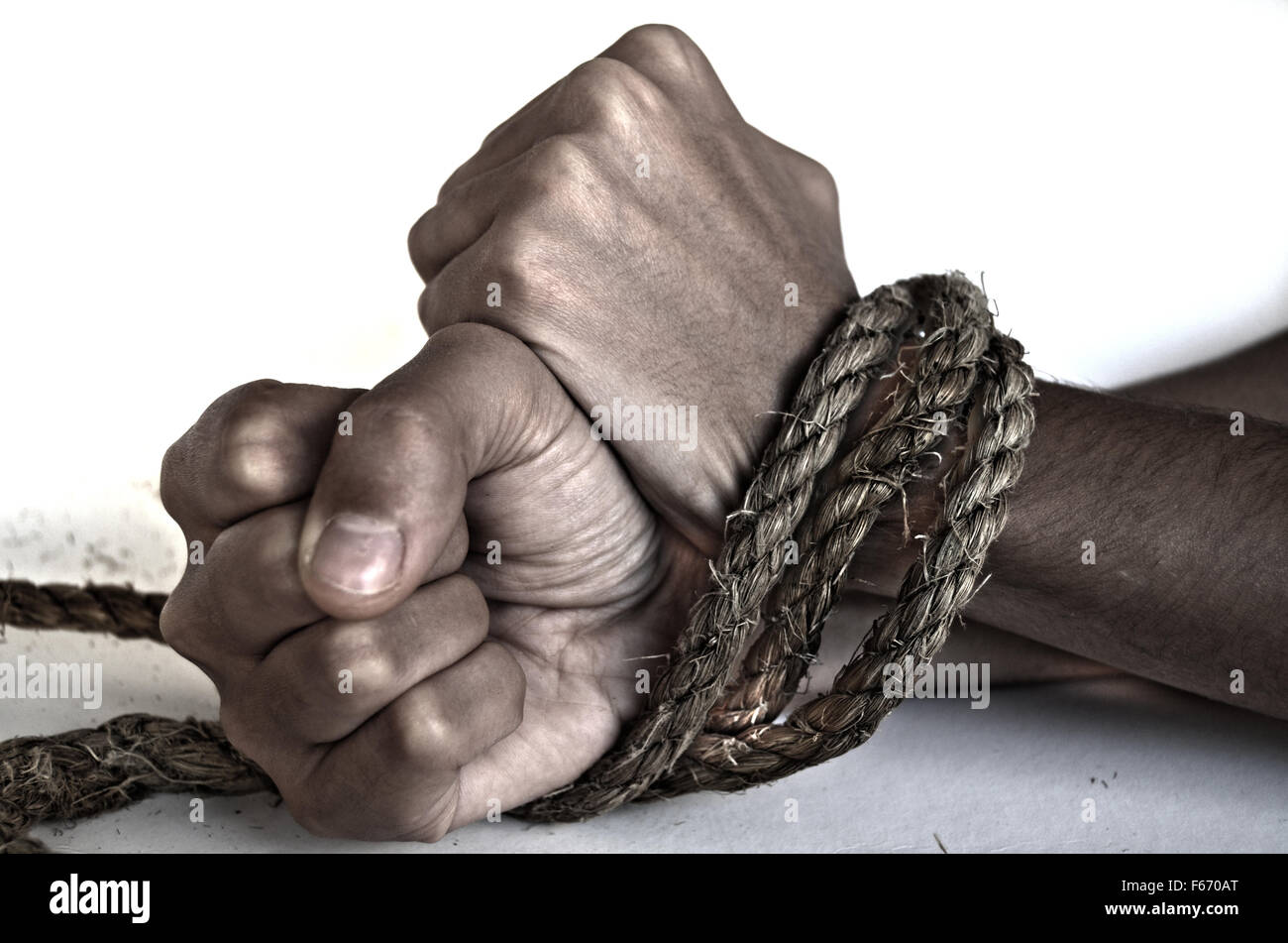 Hands of woman tied up with rope Stock Photo