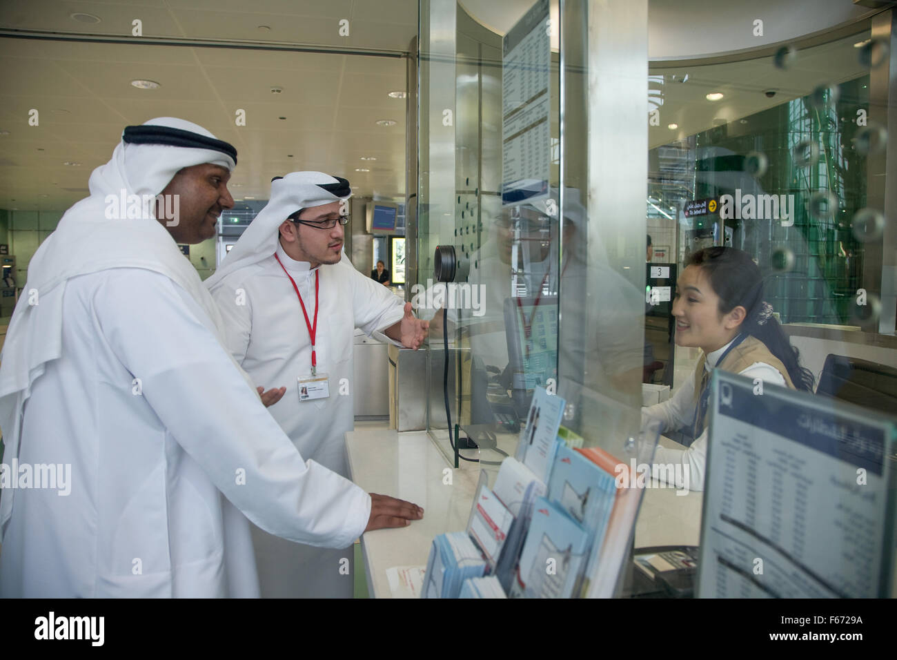 Arab man in Dubai Metro being assisted by staff Stock Photo - Alamy