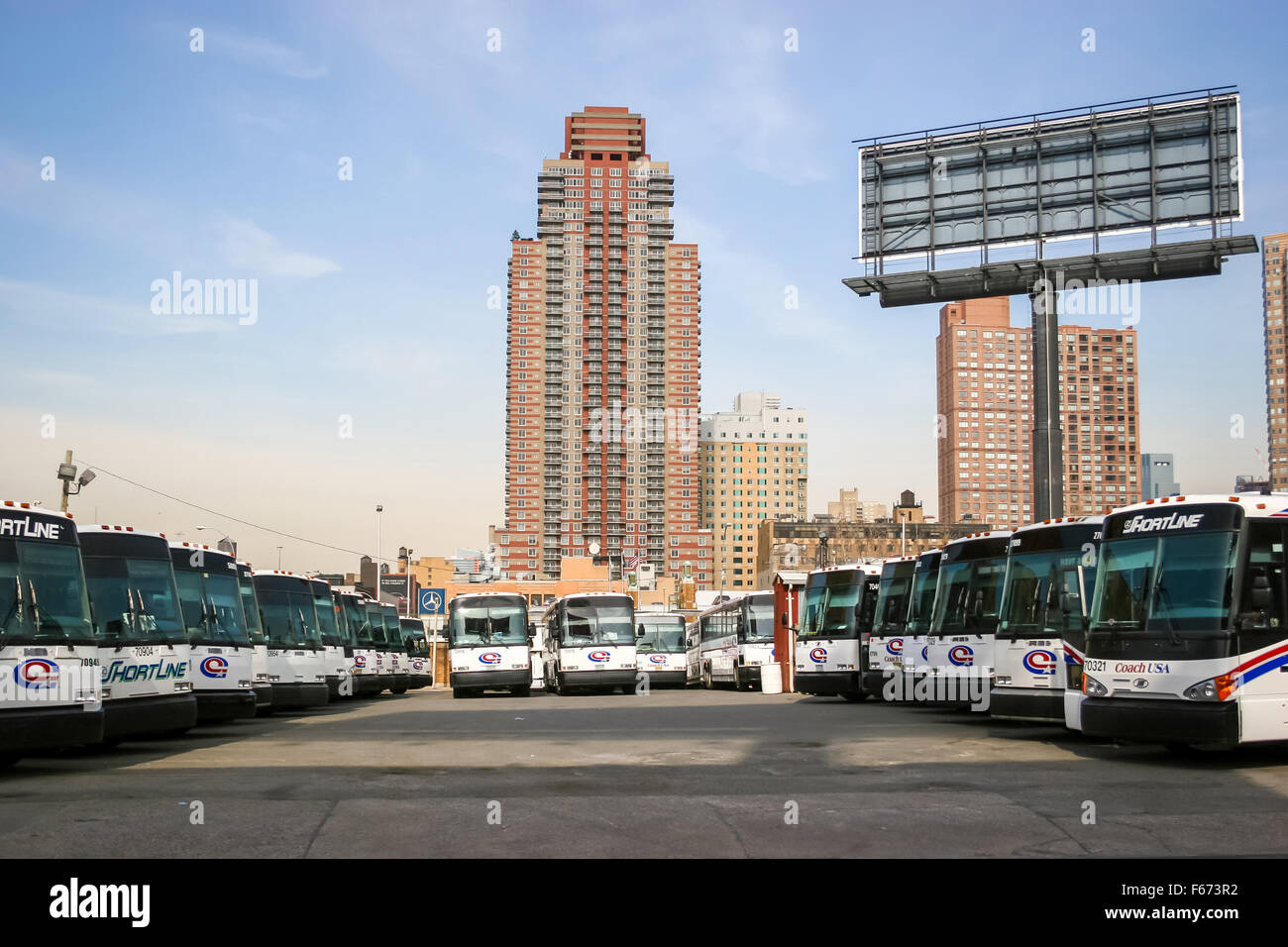 A large group of buses parked in the city bus garage on West 38 street