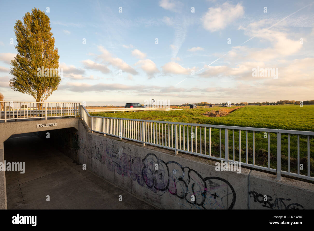 Bicycle tunnel with graffiti and road in countryside Stock Photo