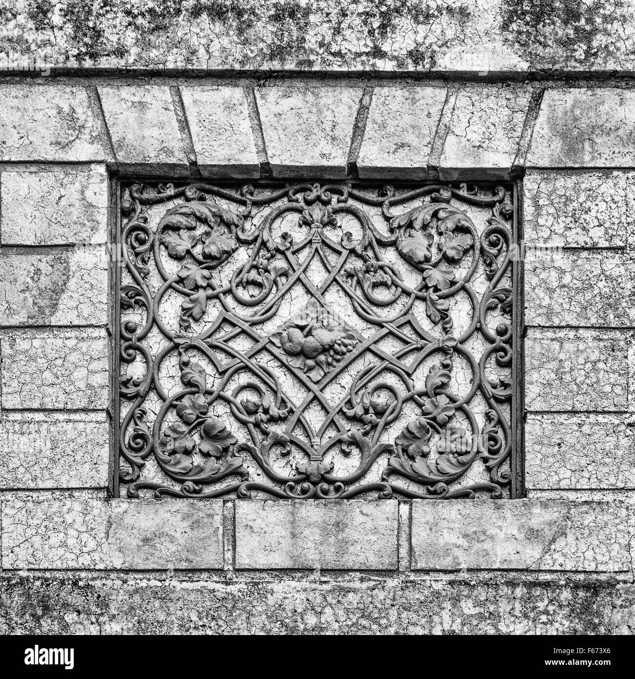 Facade of an ancient Italian villa with artistic iron grill handmade. Stock Photo