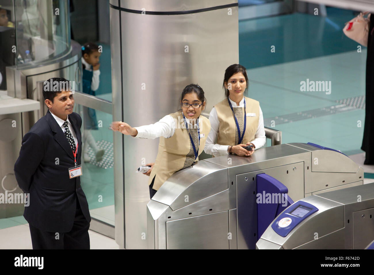 Dubai Metro station staff attending to the public Stock Photo