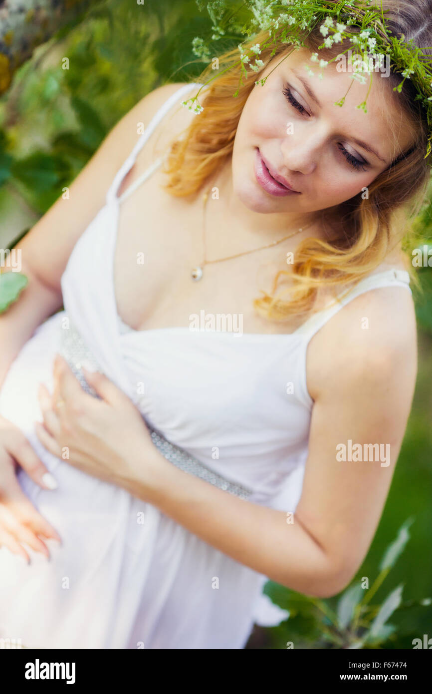 Pregnant woman in green forest Stock Photo - Alamy